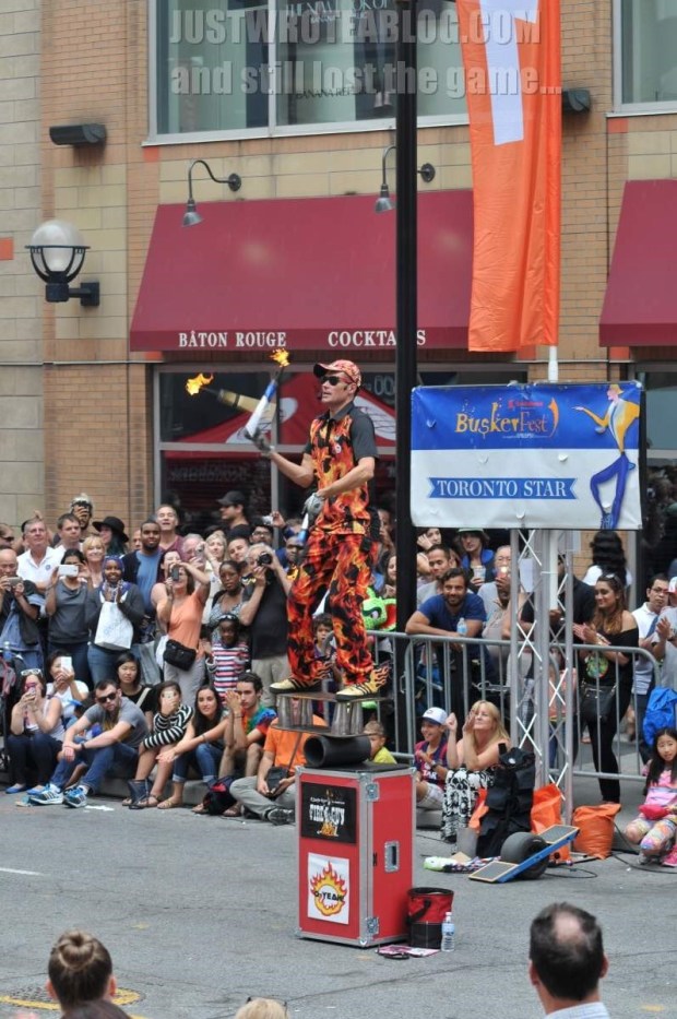 Yes, this is crazy...from bottom to top, a box, an ABS pipe, a board, what appear to be 4 martini shakers another board and Fireguy juggling torches...